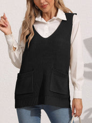Black oversized knit vest with V-neck and two patch pockets, styled over a white shirt.