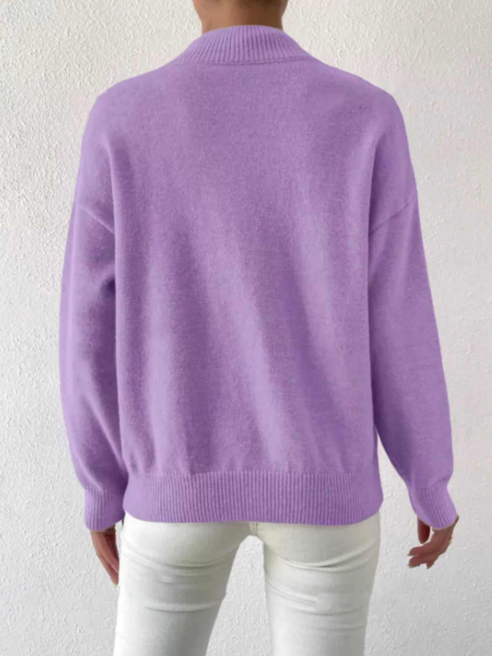 Lavender mock neck knit sweater with dropped shoulders, ribbed cuffs and hem.