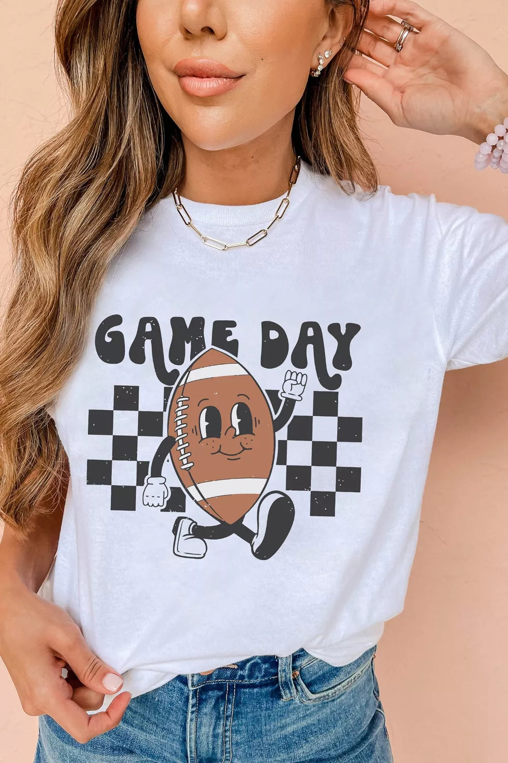 White polyester graphic tee with a retro football character and "Game Day" text.