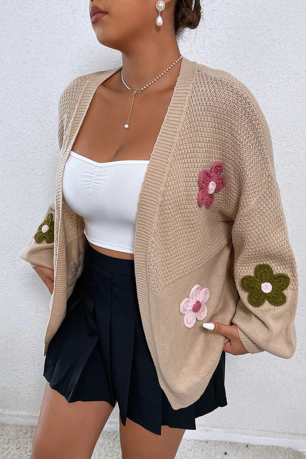 Khaki knit cardigan with embroidered pink and green flowers, open front, long sleeves.