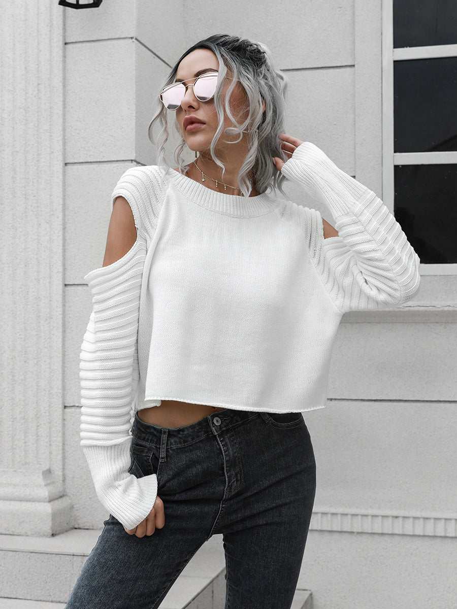 White ribbed knit cold shoulder sweater with long sleeves and a cropped hem.