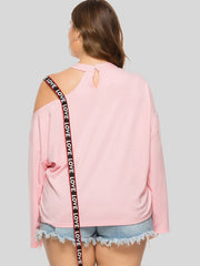 Blush pink sweatshirt with asymmetrical cut-out shoulder and "LOVE" tape detail.