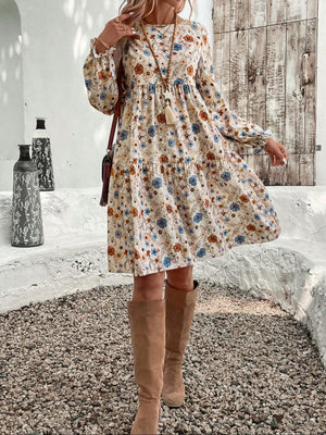 Charming beige floral tiered mini dress with long sleeves and a-line cut.