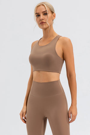 Camel sports bra with asymmetric cutout detail and racerback.