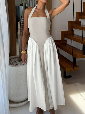 Halter neck two-tone maxi dress in beige and white with a flowing skirt.