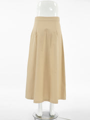 High-waisted A-line skirt in tan cotton with side pockets and a midi length.