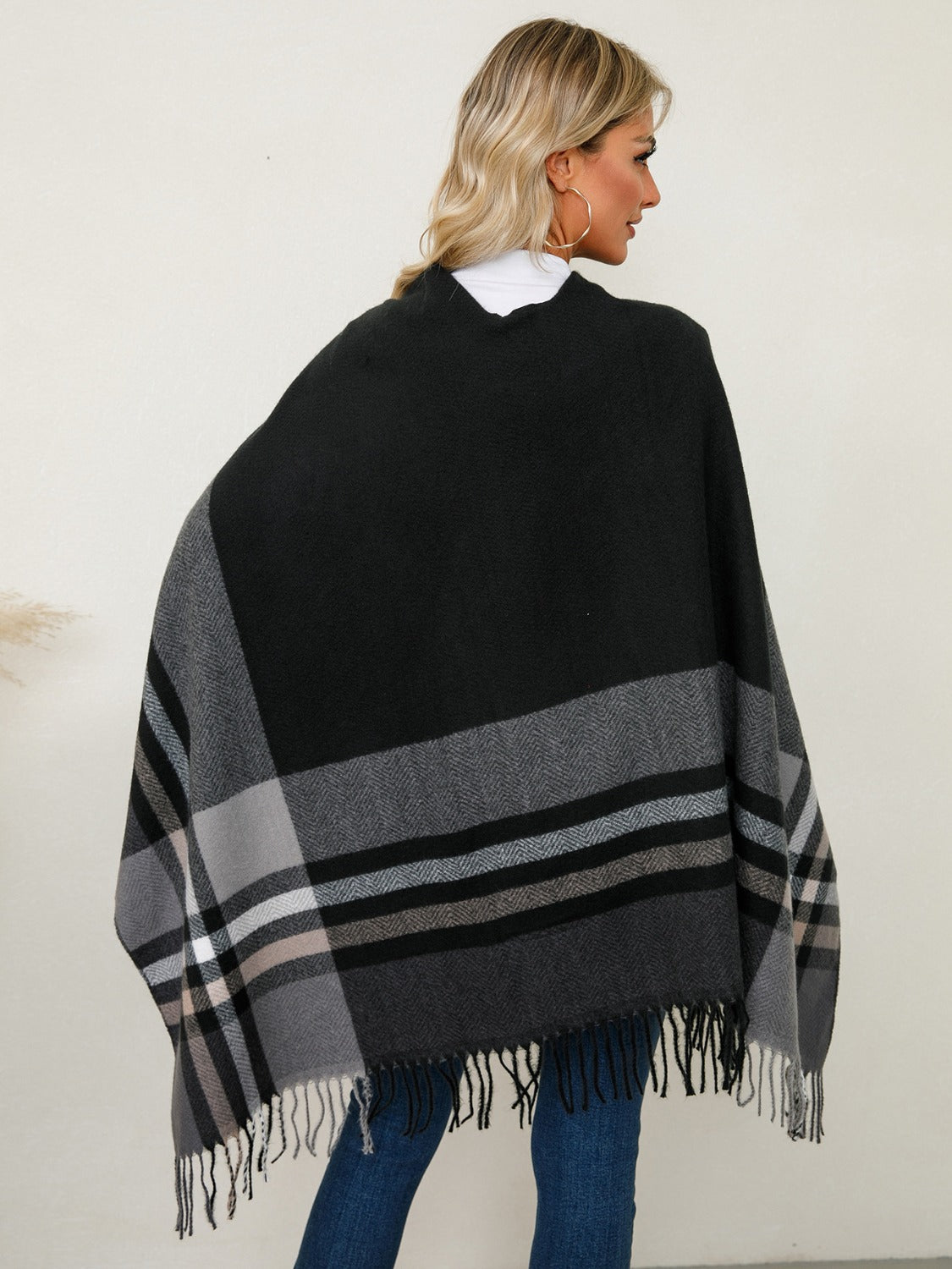 Black asymmetric plaid fringe cape with herringbone detail and fringe hem