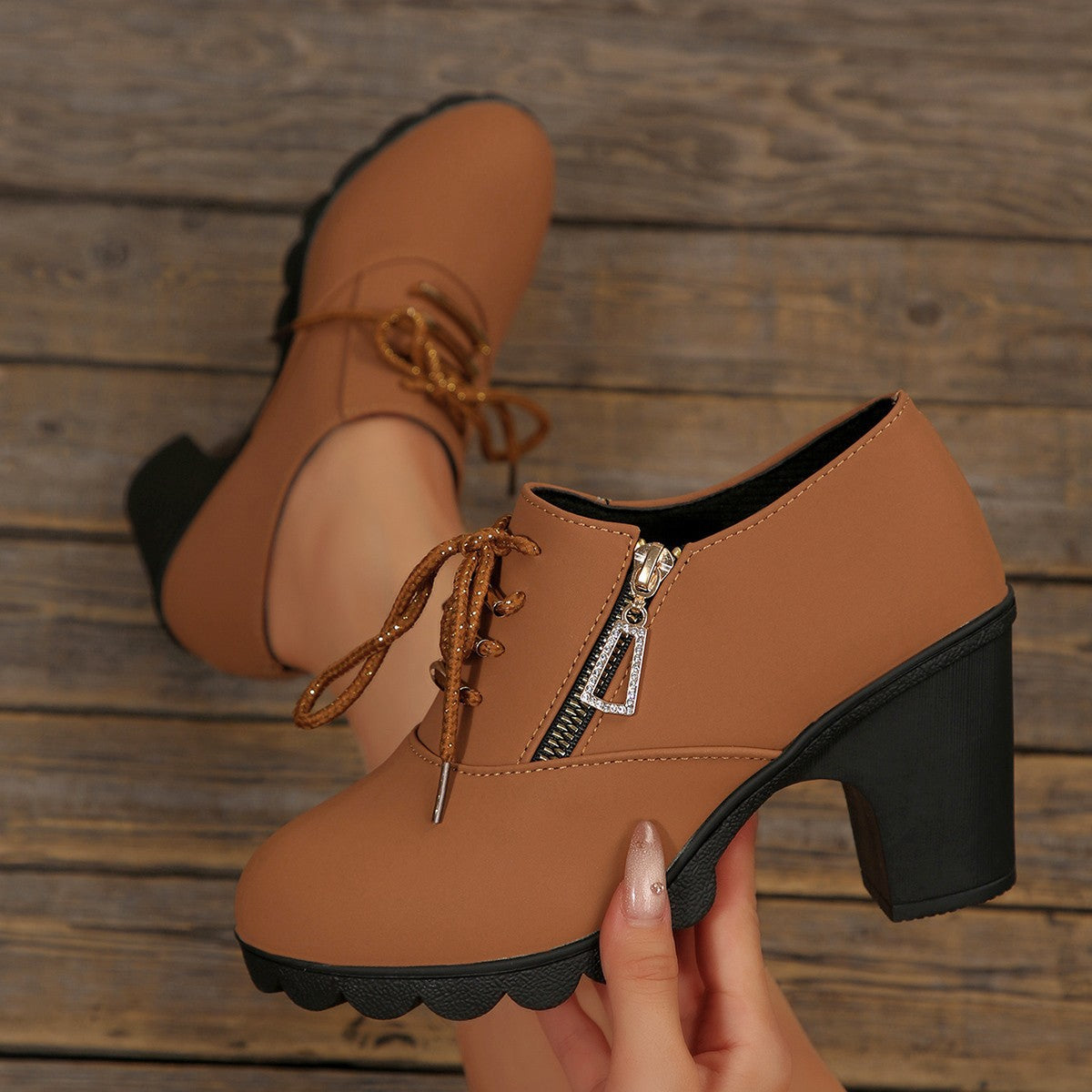 Brown lace-up high heel boots with side zipper and chunky block heel.