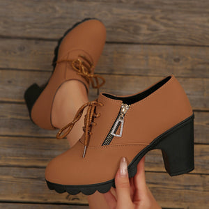 Brown lace-up high heel boots with side zipper and chunky block heel.