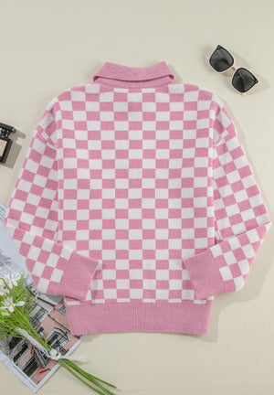 Pink checkerboard knit polo sweater with long sleeves and ribbed cuffs and hem.