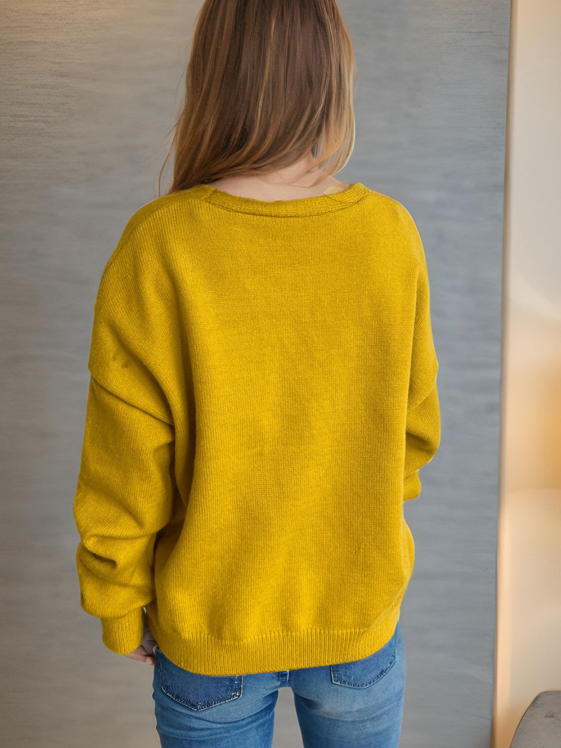 Mustard yellow acrylic oversized knit cardigan with crew neck and long sleeves.