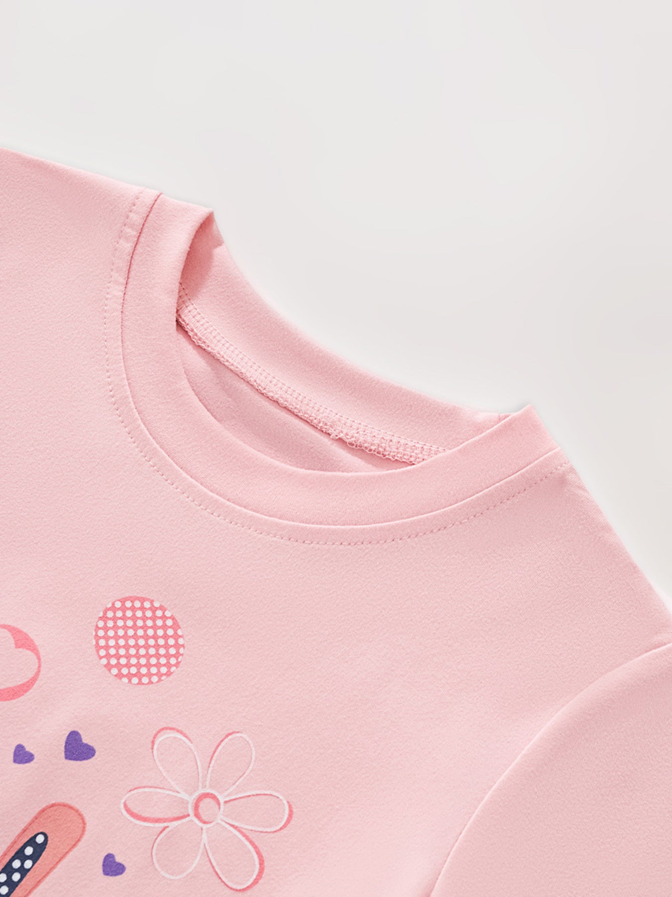 Pink toddler t-shirt with bunny, hearts, and flower graphics.