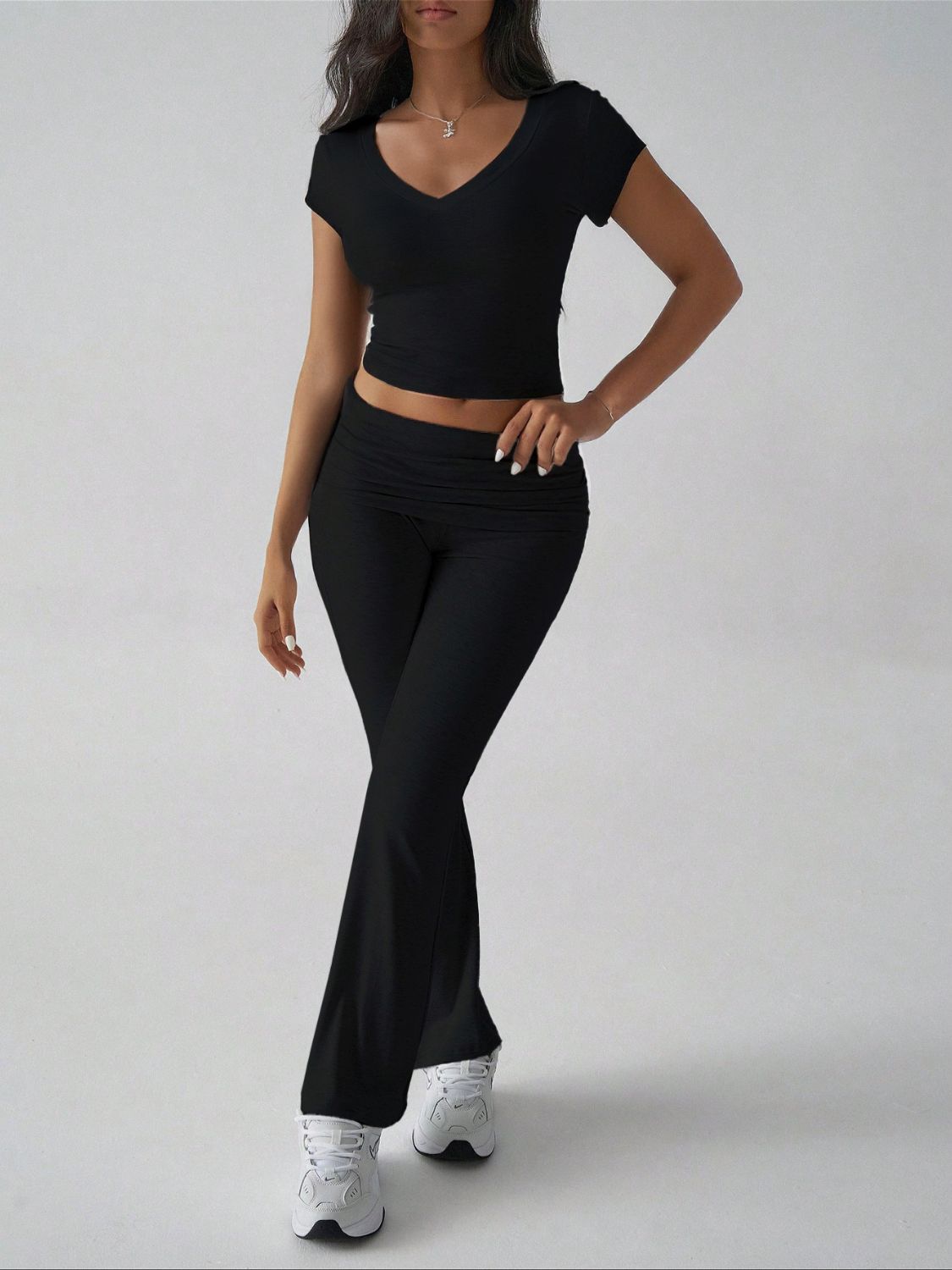 Black ribbed flare leg lounge pants with ruched waistband and v-neck crop top.