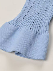 Light blue knit cardigan with openwork detail and ruffled hem.