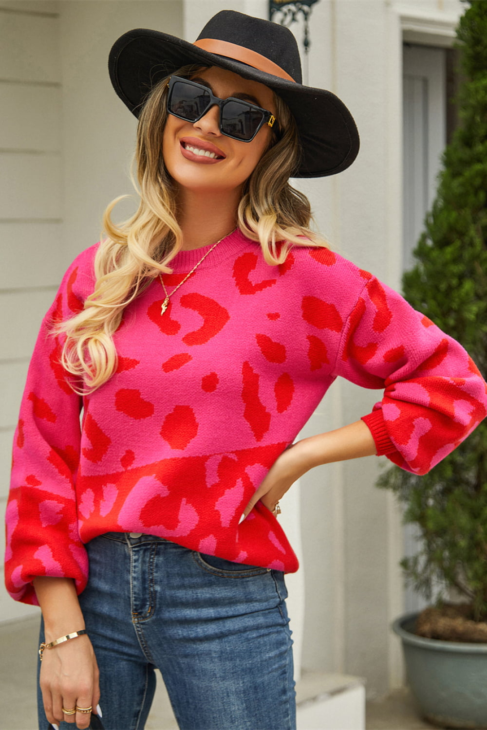 Colorblock leopard knit sweater with balloon sleeves in hot pink and red.