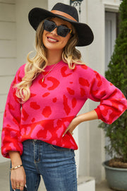 Colorblock leopard knit sweater with balloon sleeves in hot pink and red.