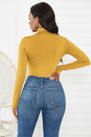 Gold turtleneck long sleeve thong bodysuit with a smooth finish.