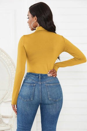Gold turtleneck long sleeve thong bodysuit with a smooth finish.