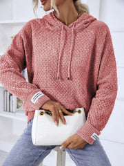 Textured knit raglan sleeve hoodie in burnt coral with drawstring hood and cuff detail.
