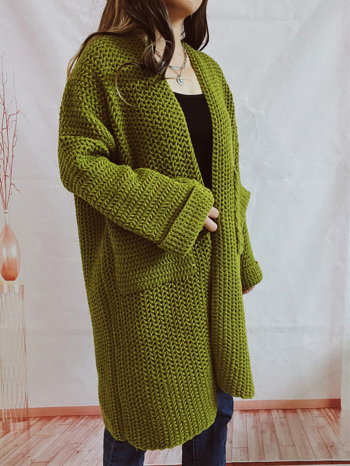 Chunky knit cocoon cardigan coat in moss green with open front and pockets.