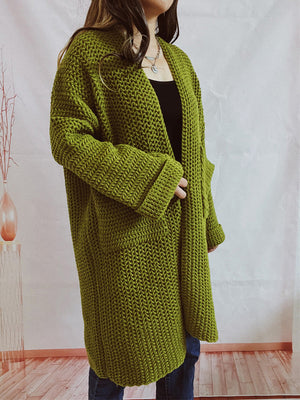 Chunky knit cocoon cardigan coat in moss green with open front and pockets.