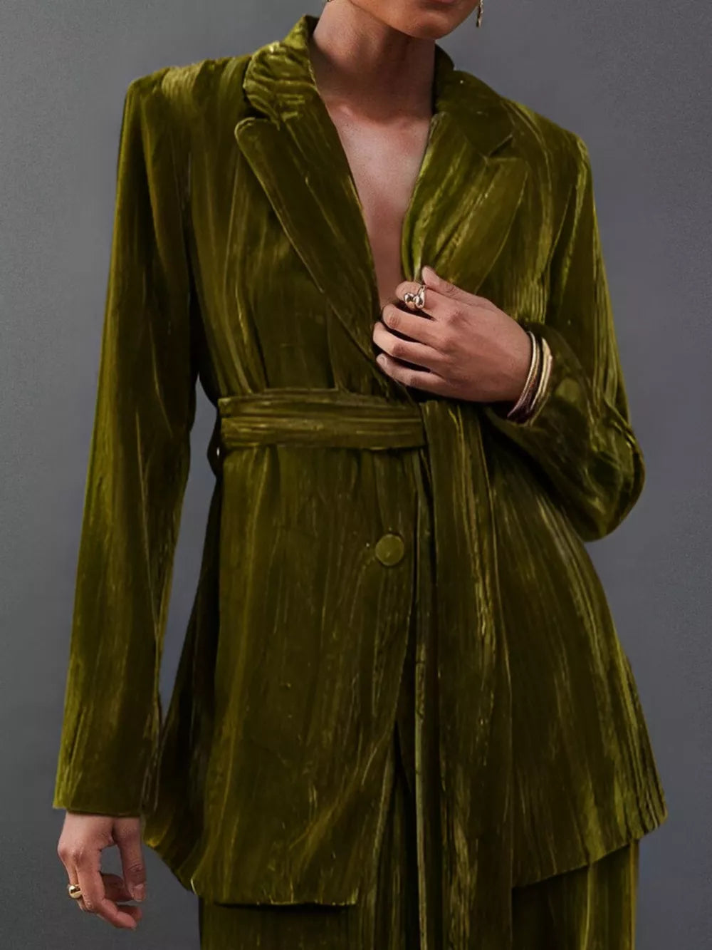 Army green velvet belted blazer and trousers ensemble with a single button closure.