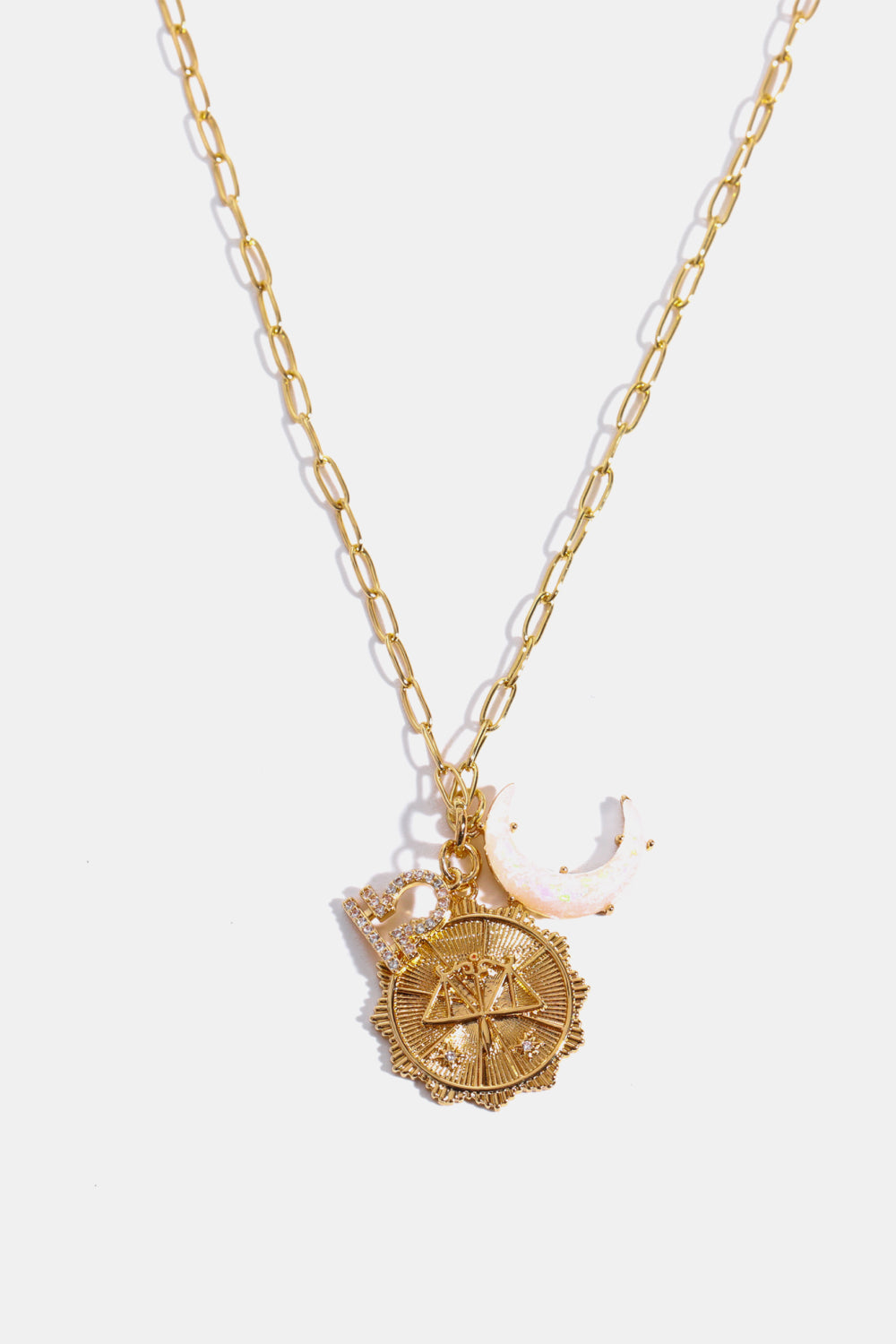 Gold zodiac pendant necklace with Libra symbol, moon charm, and diamond accents.