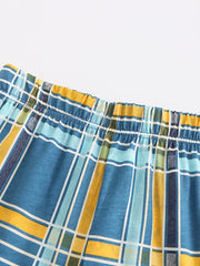 Boys' blue plaid elastic waist shorts with yellow and green accents.