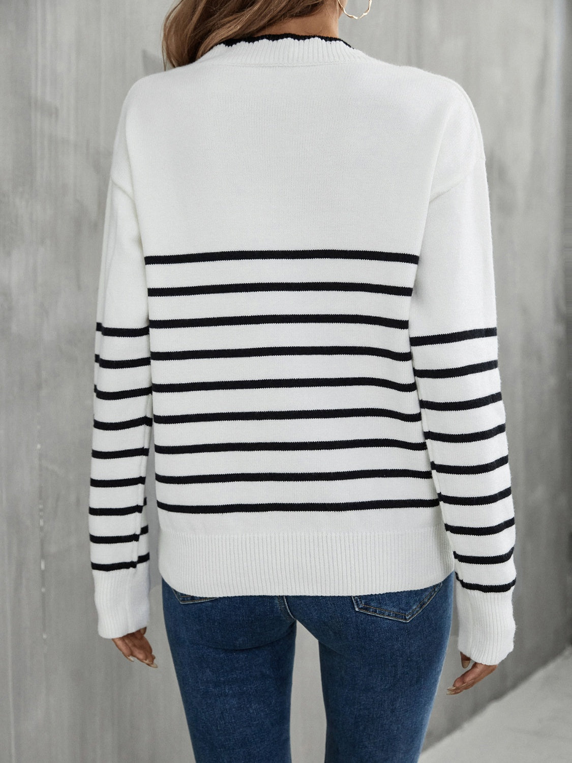 White and black striped knit sweater with scalloped trim neckline and ribbed cuffs.