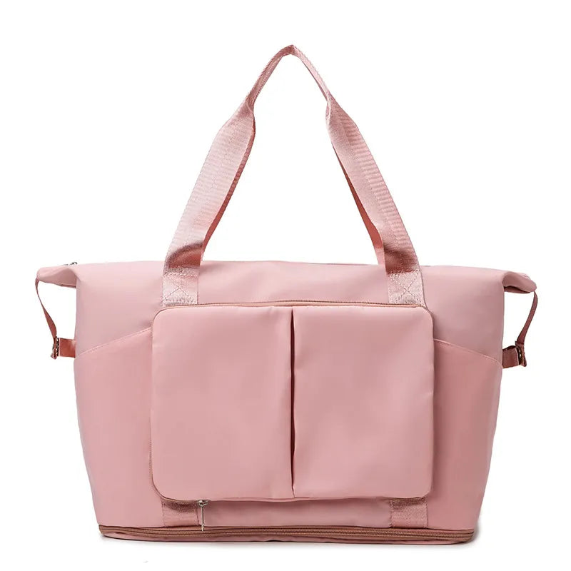 Dusty Pink foldable travel tote bag with exterior pockets and shoulder straps.