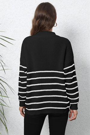 Black and white striped knit sweater with a mock neck and zip detail.
