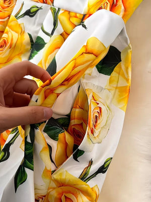Yellow floral midi dress with pleated skirt and pockets