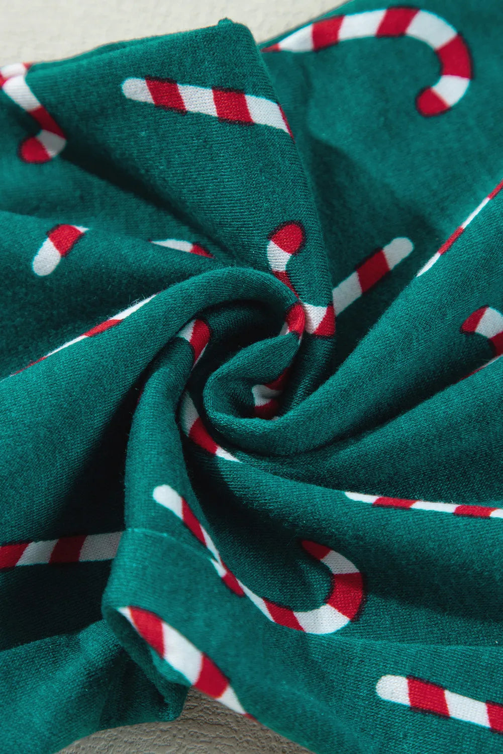 Deep teal pajamas with a red and white candy cane print.