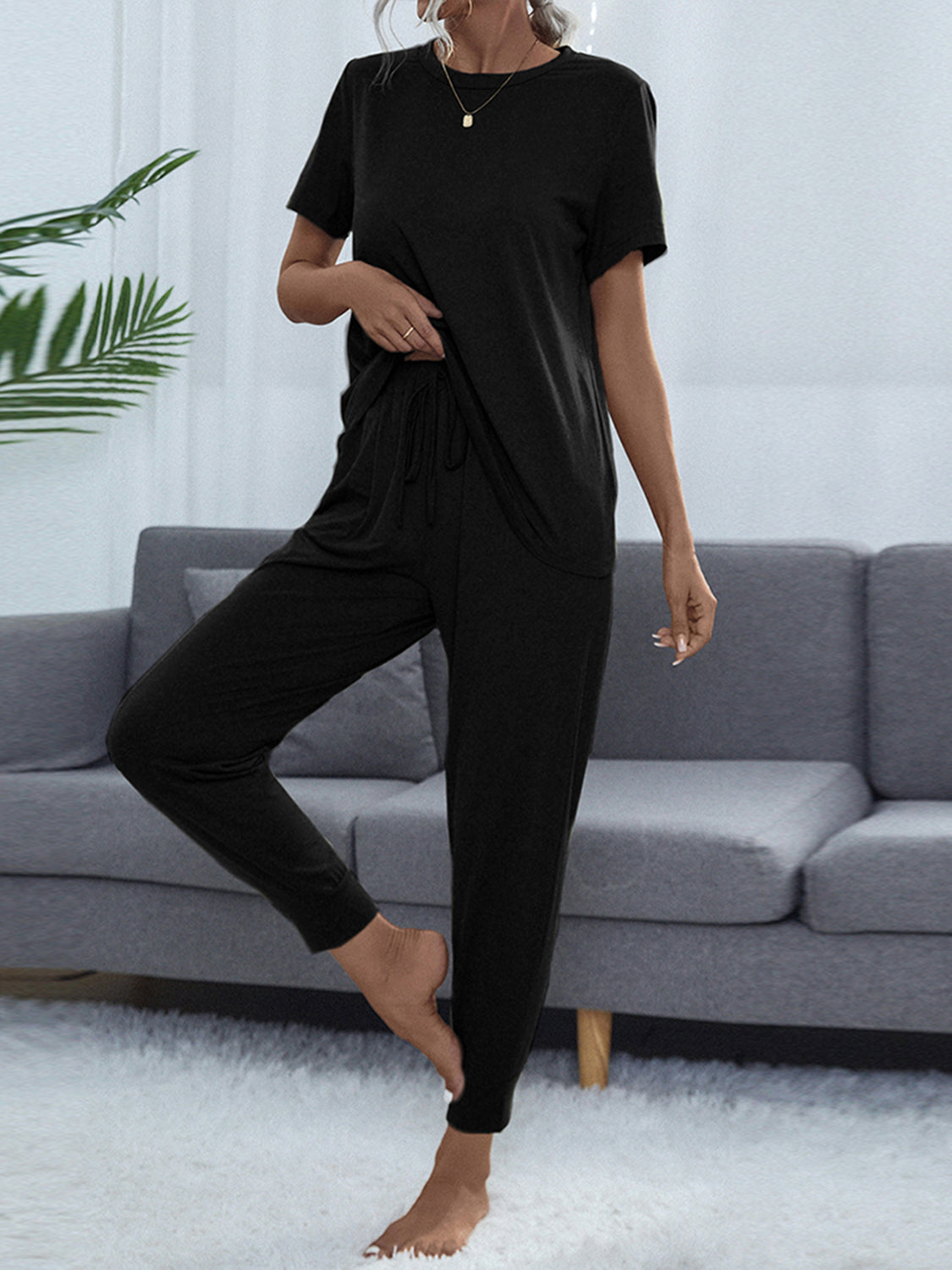 Black relaxed-fit tee and jogger lounge set with drawstring waist and cuffed ankles.
