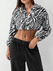 Plush cropped zebra print jacket with drawstring closure and zipper.