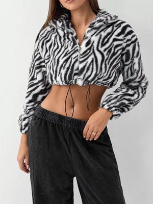 Plush cropped zebra print jacket with drawstring closure and zipper.