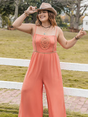 Orange wide leg jumpsuit with embroidered bodice and gold trim detail.