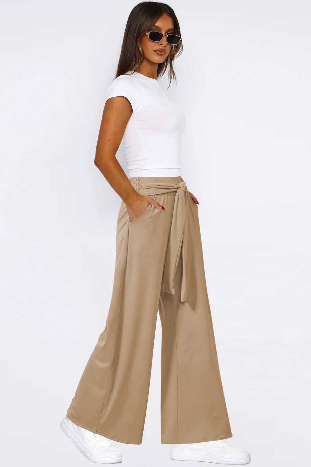 Tan soft drape palazzo trousers with tie waist and pockets.