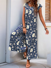Navy botanical print culotte jumpsuit with cap sleeves and a scoop neck.