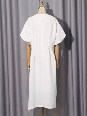 White midi dress with puff sleeves and a-line cut, featuring subtle texture.