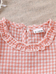 Children's blush pink gingham cotton ruffle top with a size tag.
