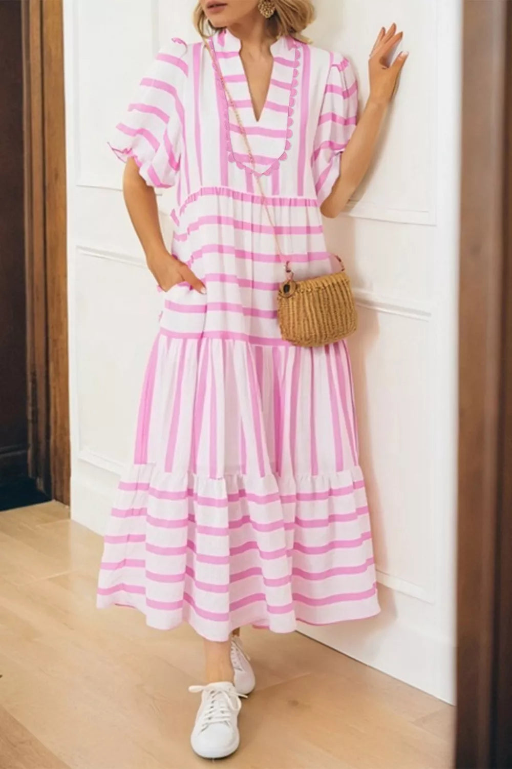 Maxi dress with pink and white stripes, notched neckline, short sleeves, and tiered skirt.