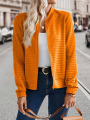 Quilted bomber jacket in Tangerine with zip closure and textured pattern.
