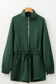 Dark green drawstring waist romper with funnel neck and quarter zip