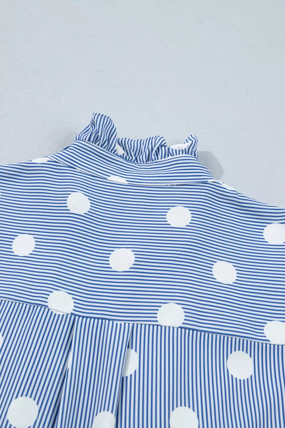 Blue and white striped and polka dot ruffled shirt with button-down detail