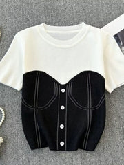 Color block knit t-shirt in white with black bustier detail, ribbed neckline and button front.