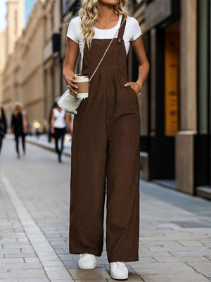 Brown corduroy wide-leg suspender jumpsuit with buttoned straps and pockets.