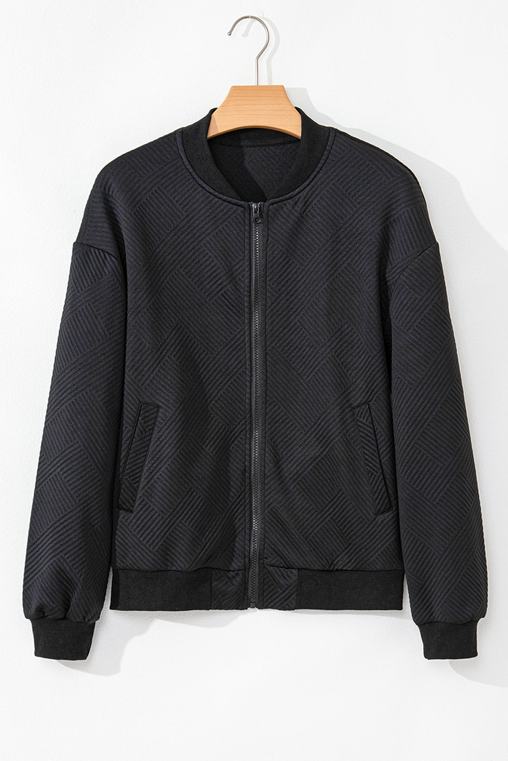 Black bomber jacket with diamond quilting and zip front.