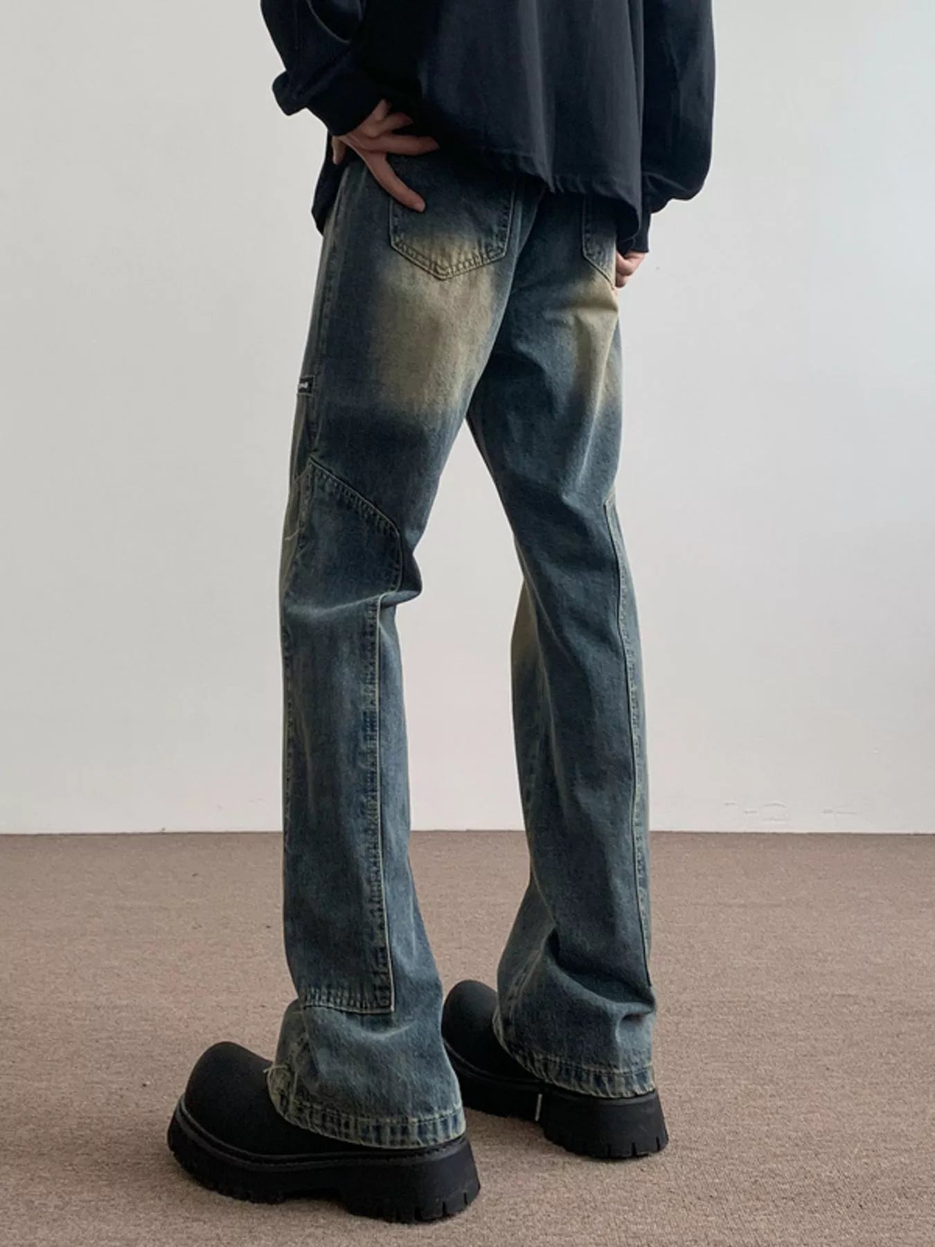 Men's blue vintage wash flare jeans with distressed details