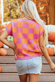 Checkerboard knit cap-sleeve top in pink and orange plaid.